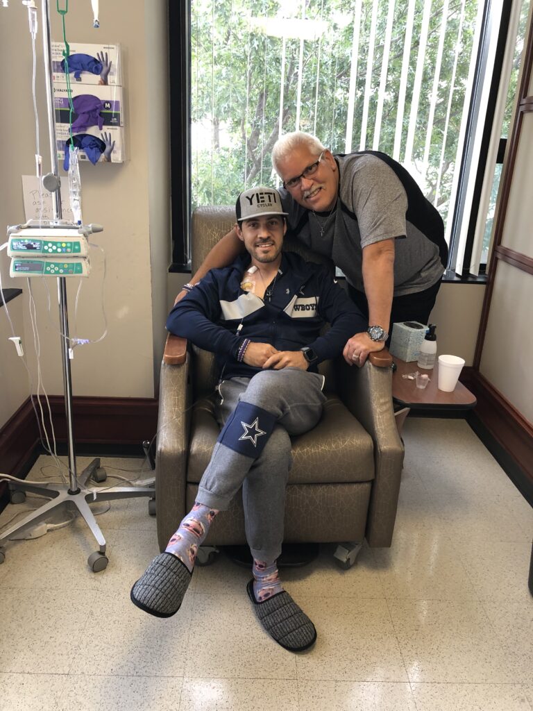 father and son at the hospital while son gets chemo infusion
