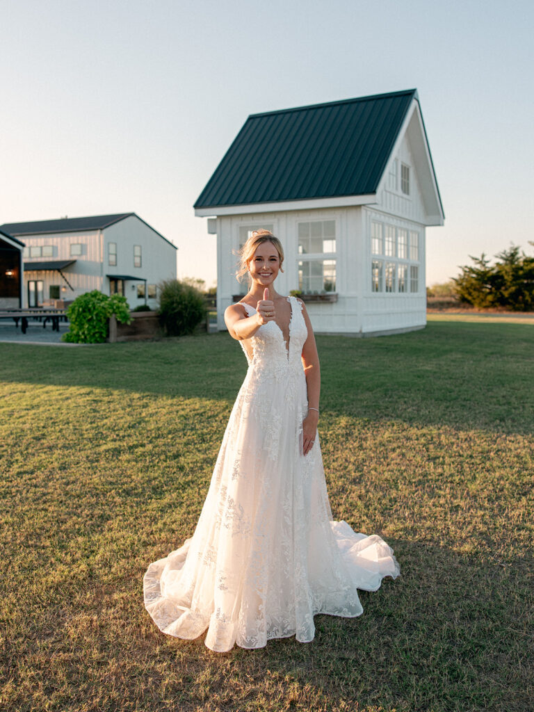 Bride showing off a gig em thumbs up during bridal session 