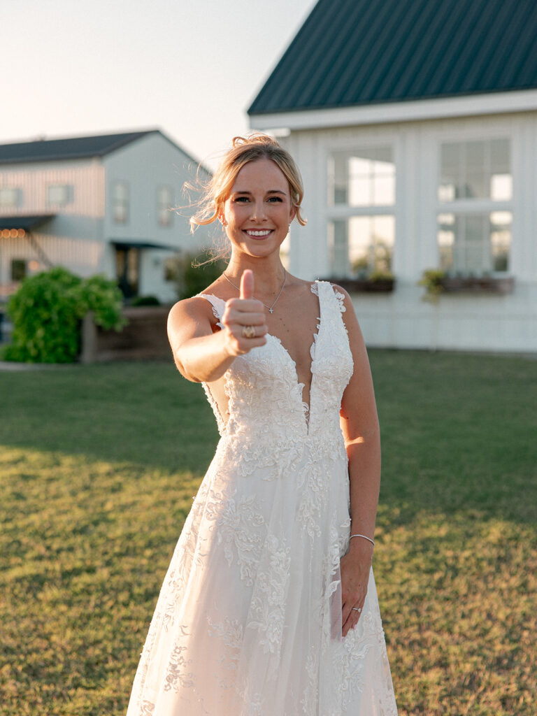 Bride showing off a gig em thumbs up during bridal session 