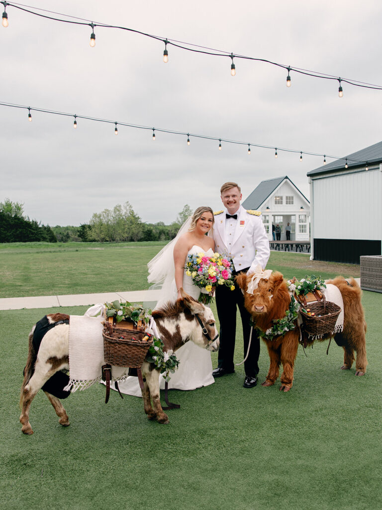 bride and groom pose outdoors at their wedding at Davis & Grey Farms with 2 beer burros
