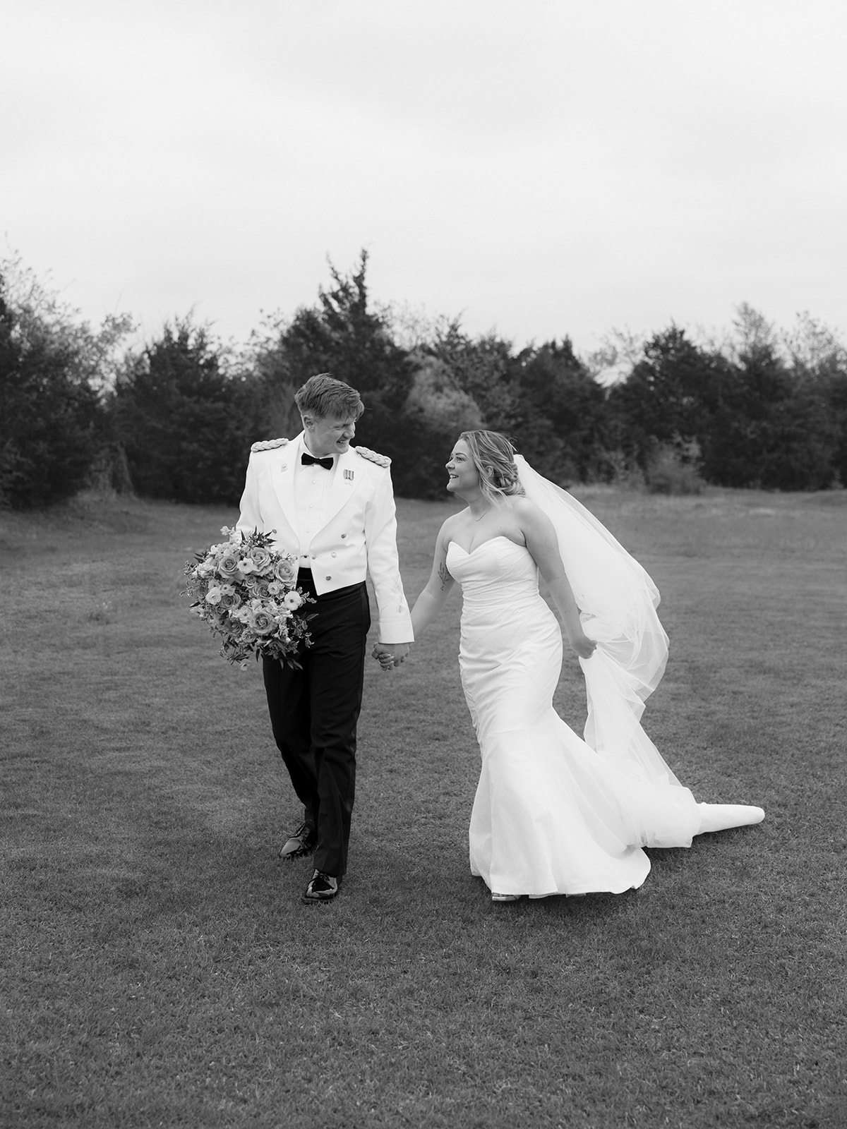 black and white images of a Bride and Groom after wedding ceremony taking husband and wife photos in a field