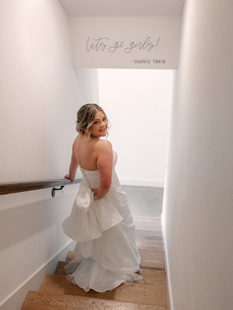 bride walking down the stairs before the first look with her groom