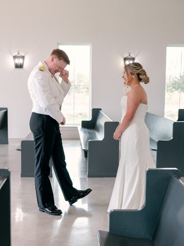 groom seeing bride for the first time during the first look at the indoor chapel for their wedding at Davis & Grey Farms