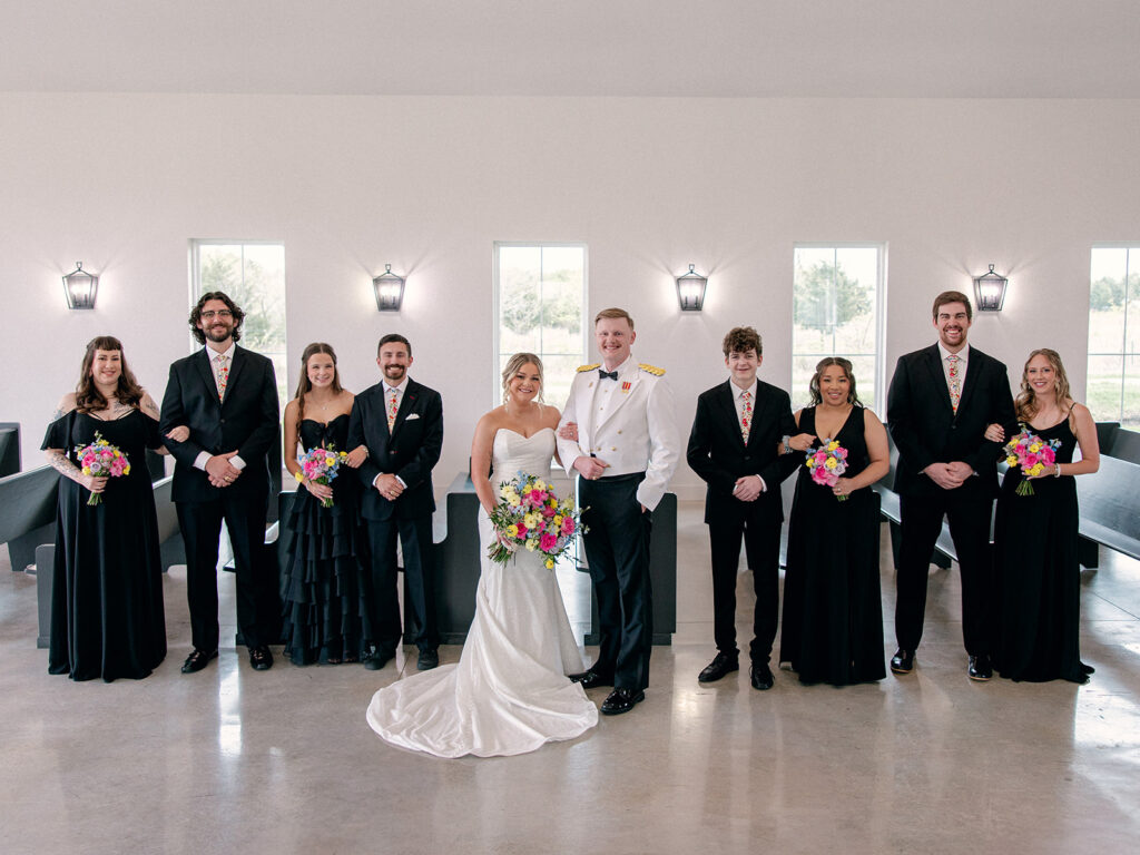 wedding party in the indoor chapel posing for a photo for the wedding at Davis & Grey Farms