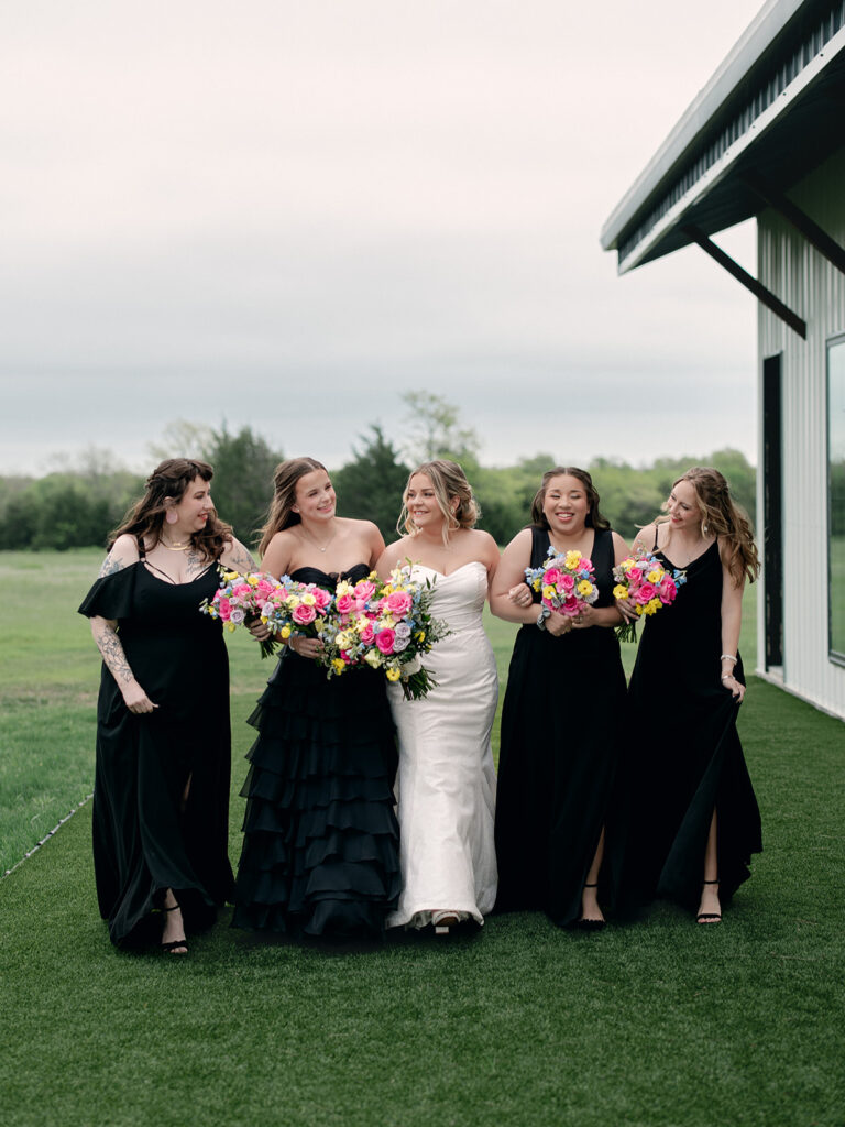 bridesmaids and bride walking together outside during the wedding at Davis & Grey Farms