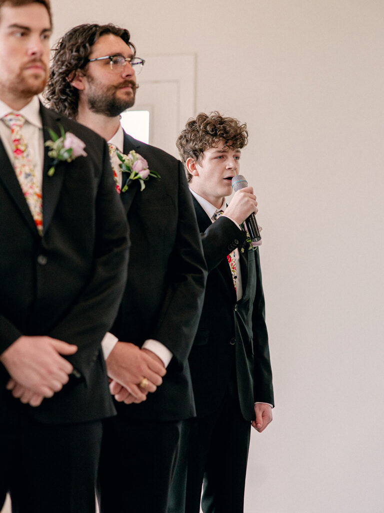 bride's brother and also groomsmen signing as the bride walks down the aisle