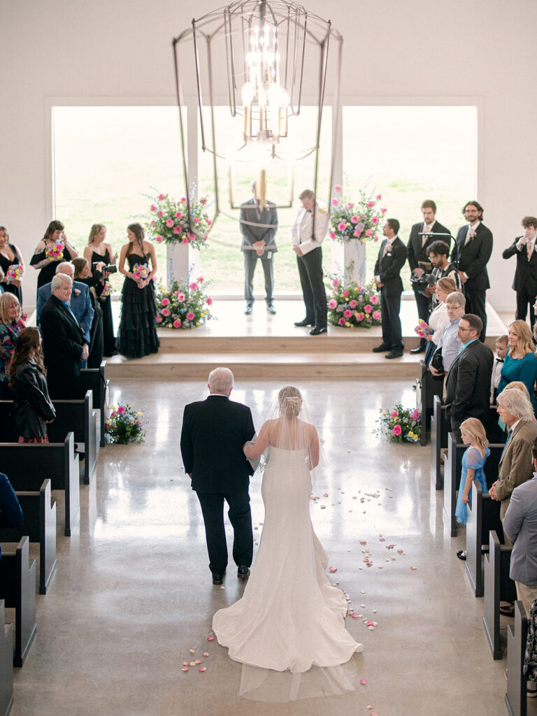 bride walking down the aisle to her groom an overhead view