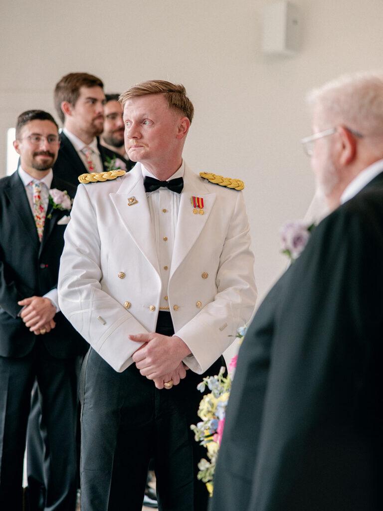 groom tearing up looking away anticipating bride's entrance