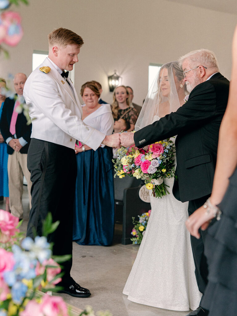 groom fist bumping father of bride moments before he hands off his daughter
