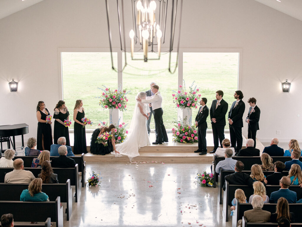 groom removing blusher from bride's face at the altar for their wedding at Davis & Grey Farms
