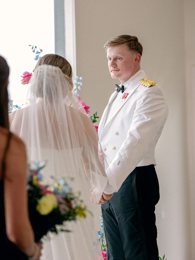 groom gazing at the bride at the altar
