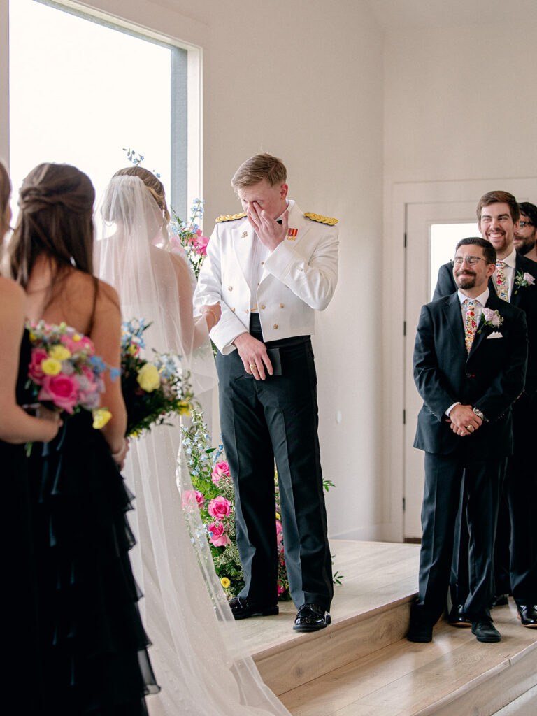 groom tears up at the altar