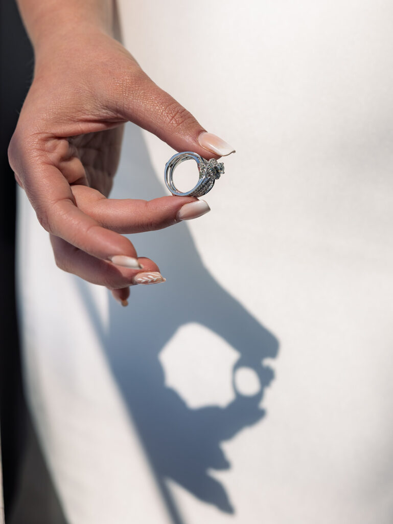 Bride showing her ring with shadows