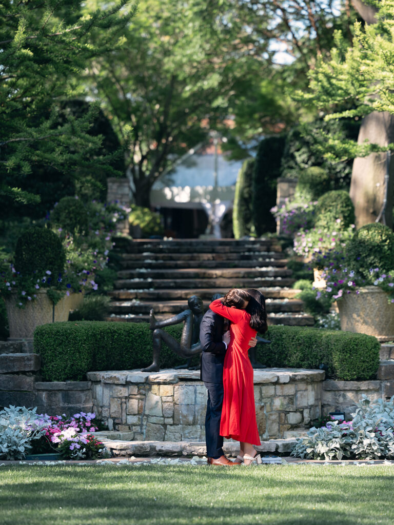 hugging after she said yes at a proposal at the dallas arboretum