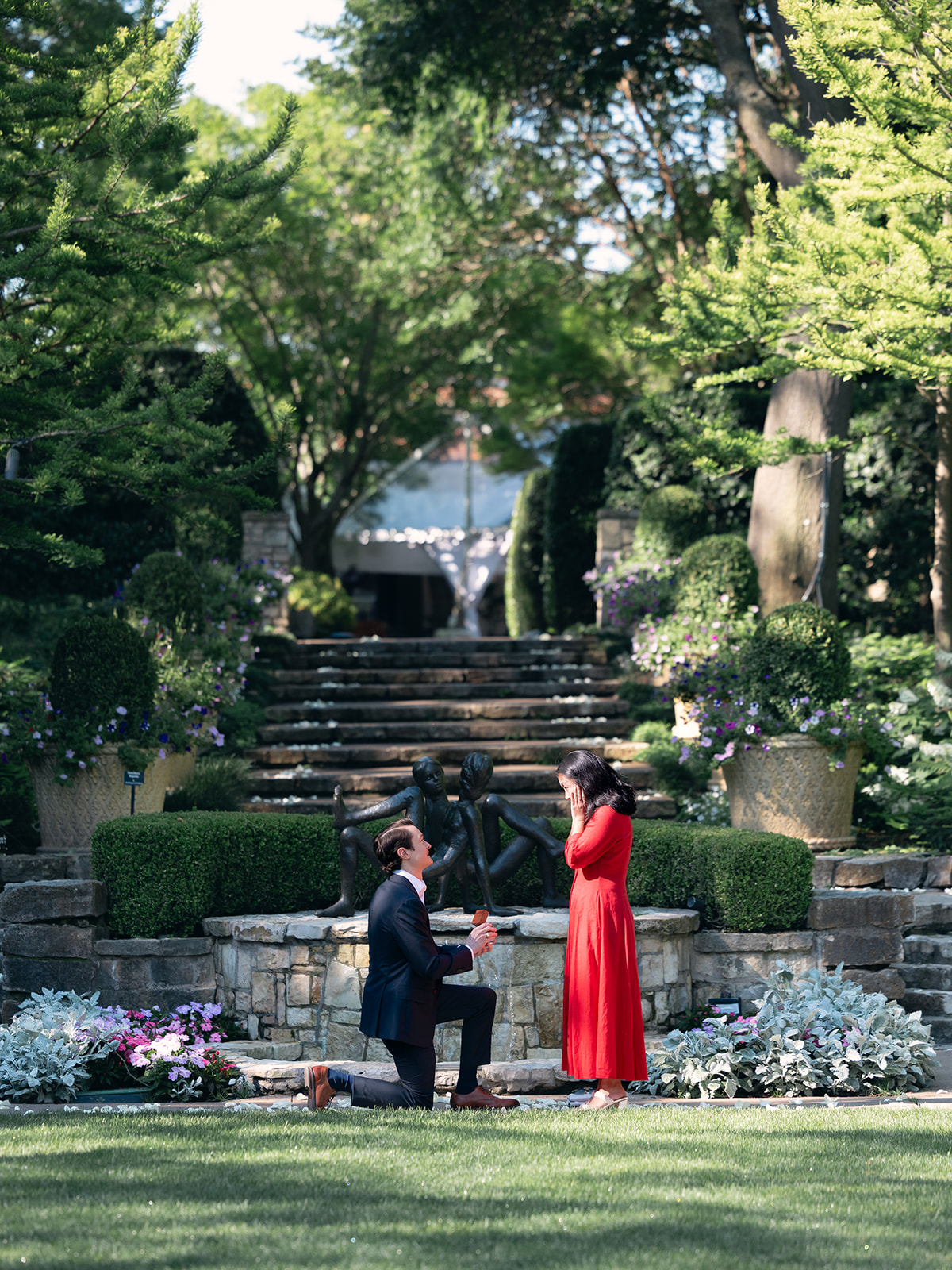 man proposing to woman on one knee in the Sunken Garden at the Dallas Arboretum