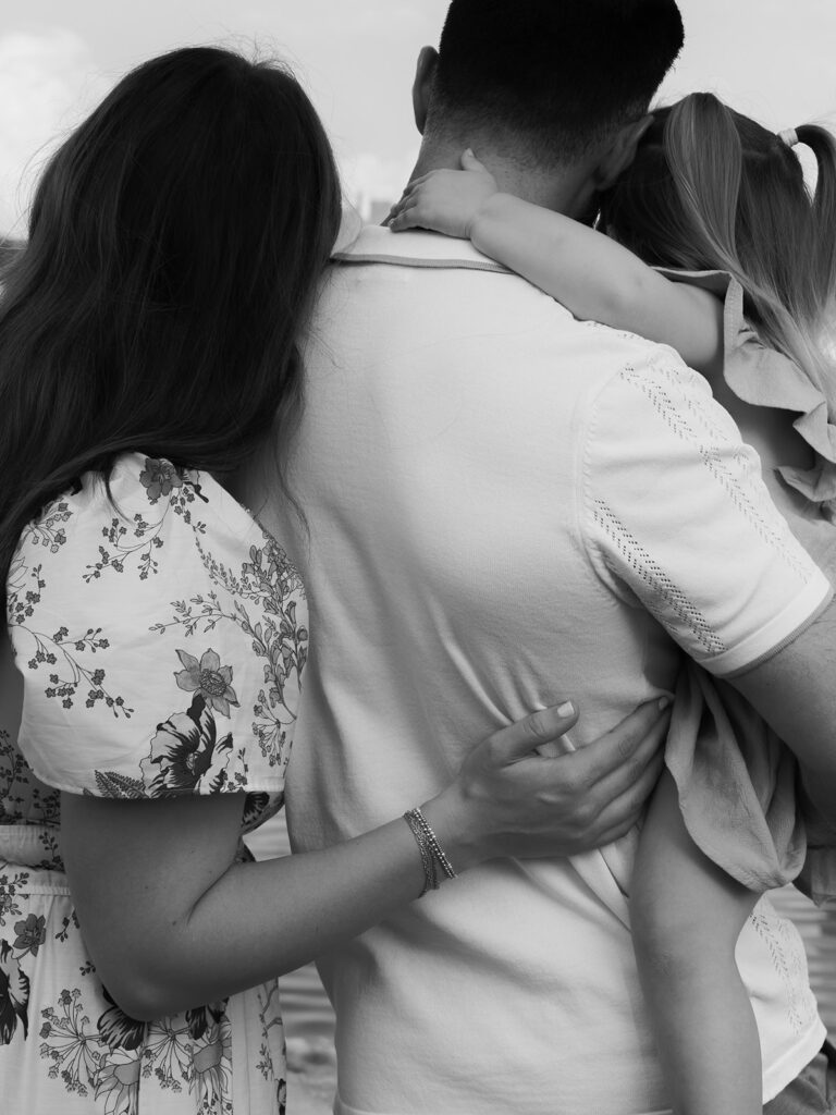 mom dad and young daughter walking away from camera during family photo session in north dallas