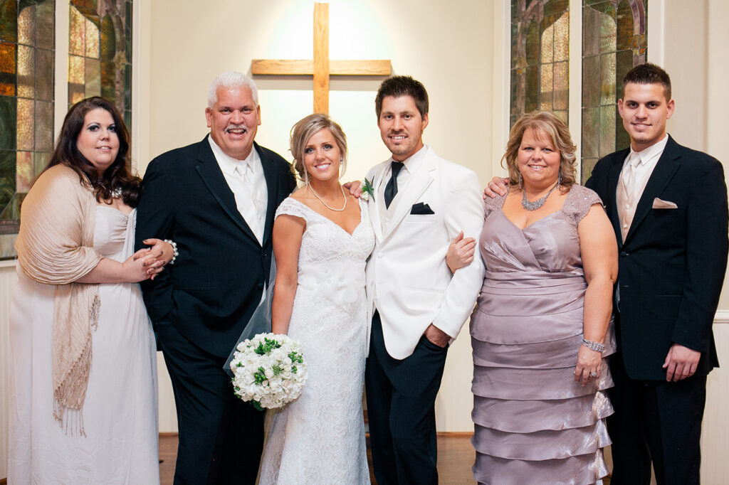 parents and bride and groom on wedding day at the altar