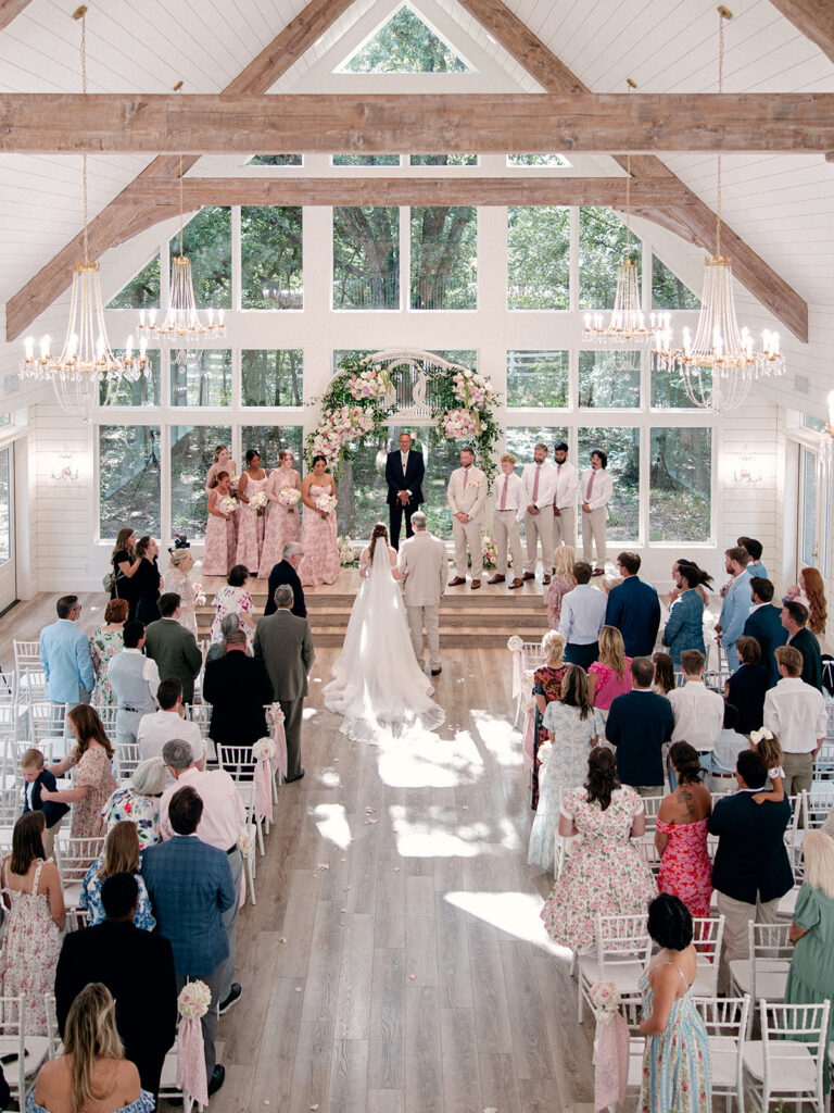 Bride walking down the aisle inside The French Farmhouse chapel in Collinsville Texas