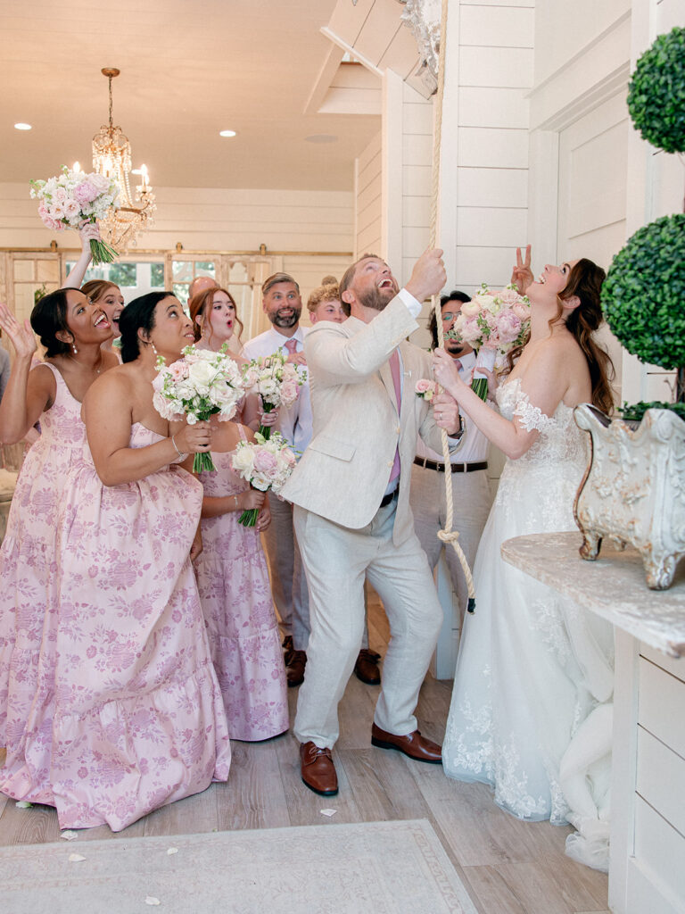Bride and groom celebrating with their wedding party