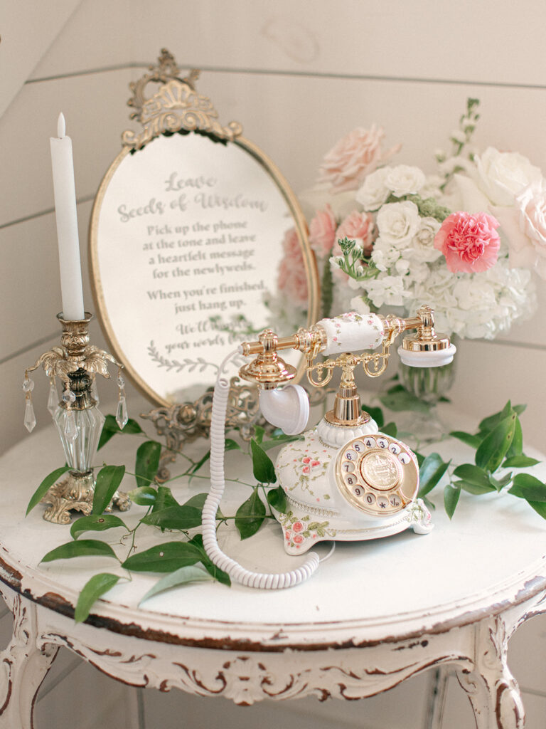Vintage phone guest book with candles pink flowers and greenery