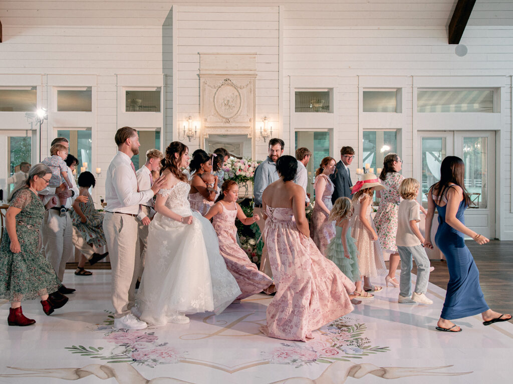Guests dancing on the custom floral dance floor