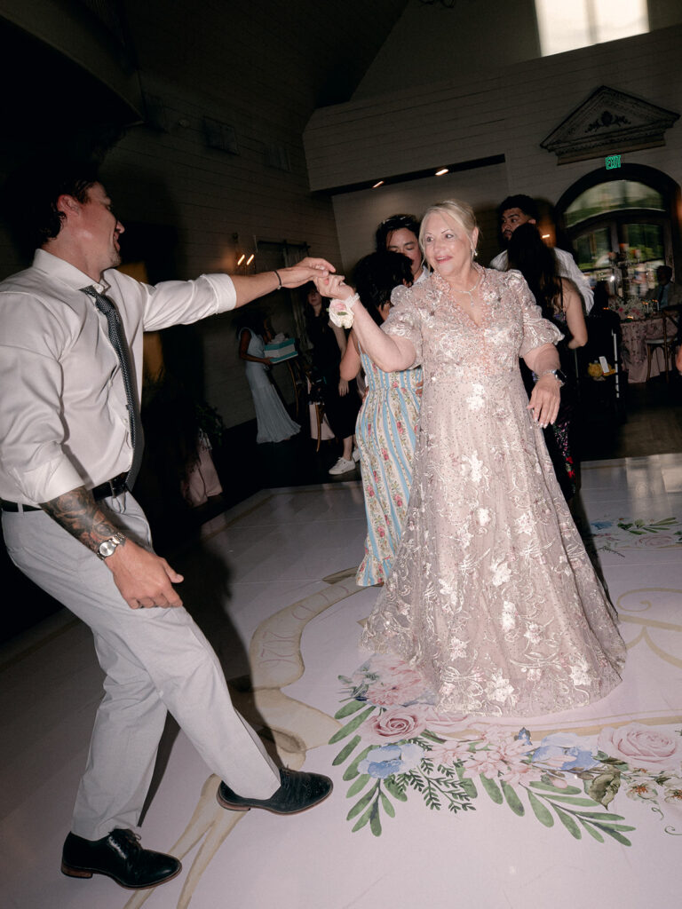 Guests laughing and dancing during the reception